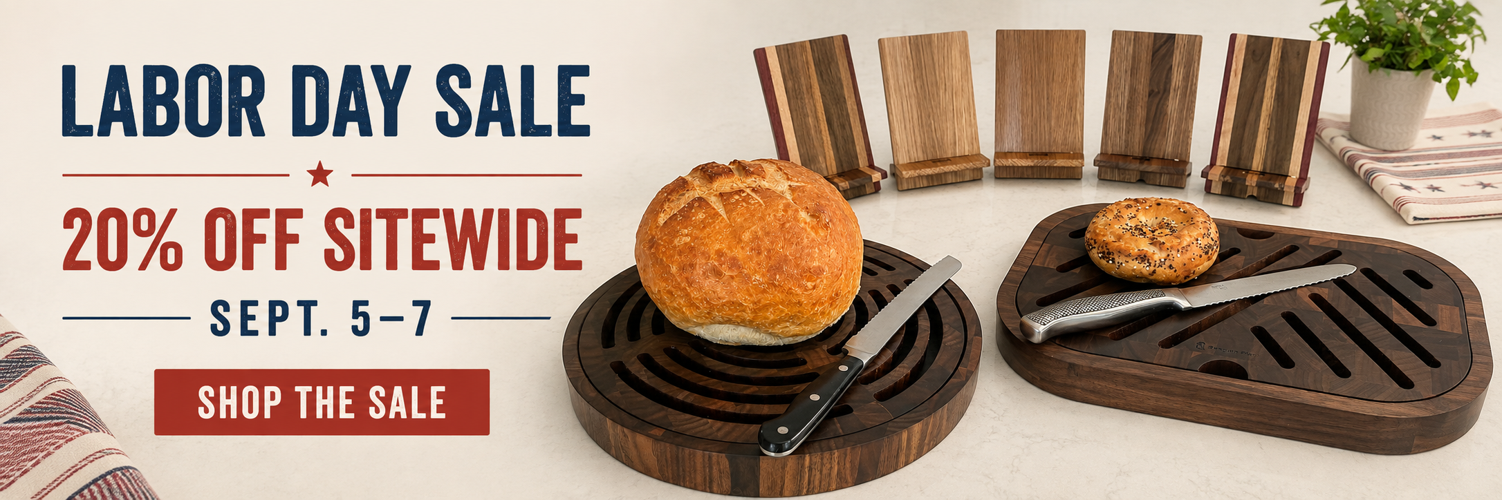 Labor Day sale promotional banner featuring two dark wood cutting boards with food items on them, alongside large sale text reading 'Labor Day Sale', '20% off sitewide', and 'Sept. 5-7 Shop the Sale'.