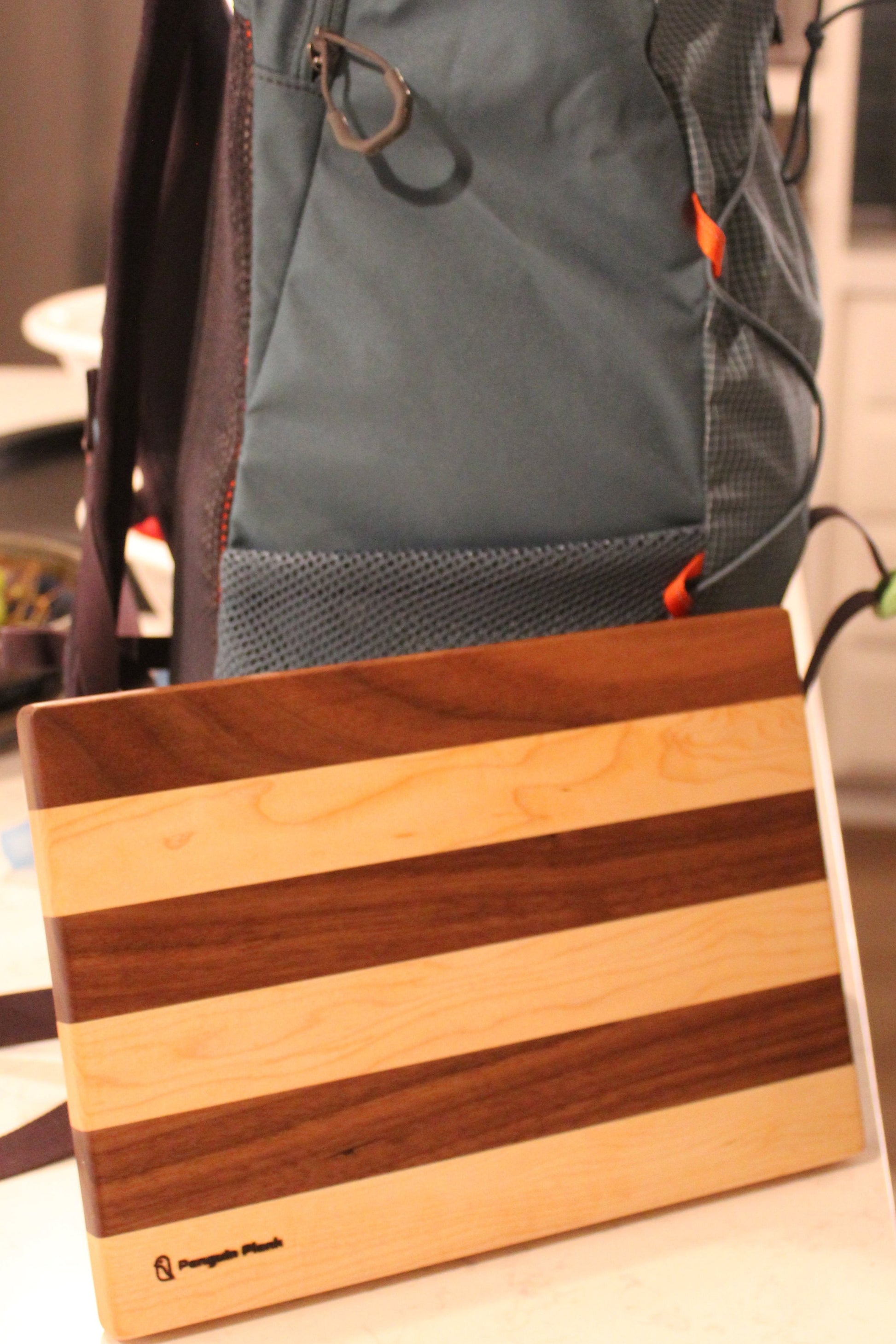 Maple and walnut picnic cutting board with backpack.