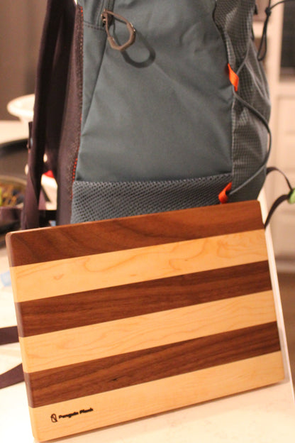 Maple and walnut picnic cutting board with backpack.