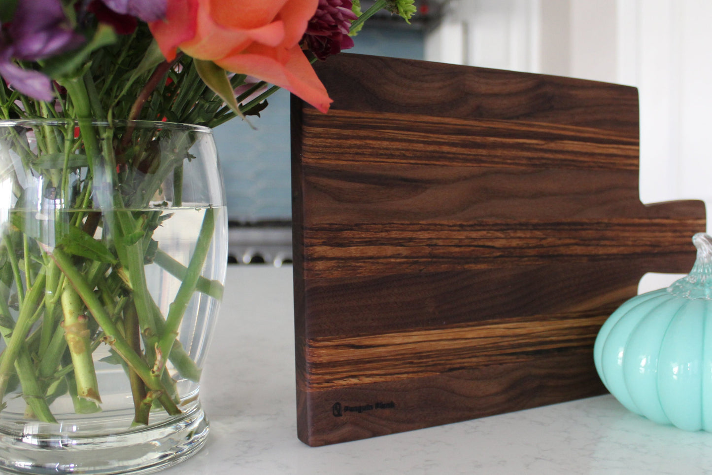 Walnut and zebrawood cheeseboard with handle.