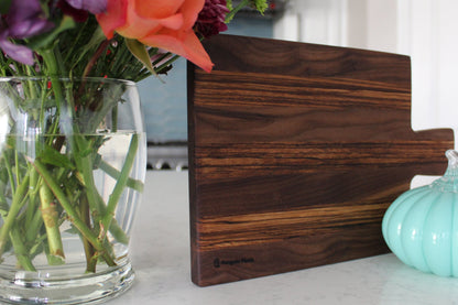 Walnut and zebrawood cheeseboard with handle.