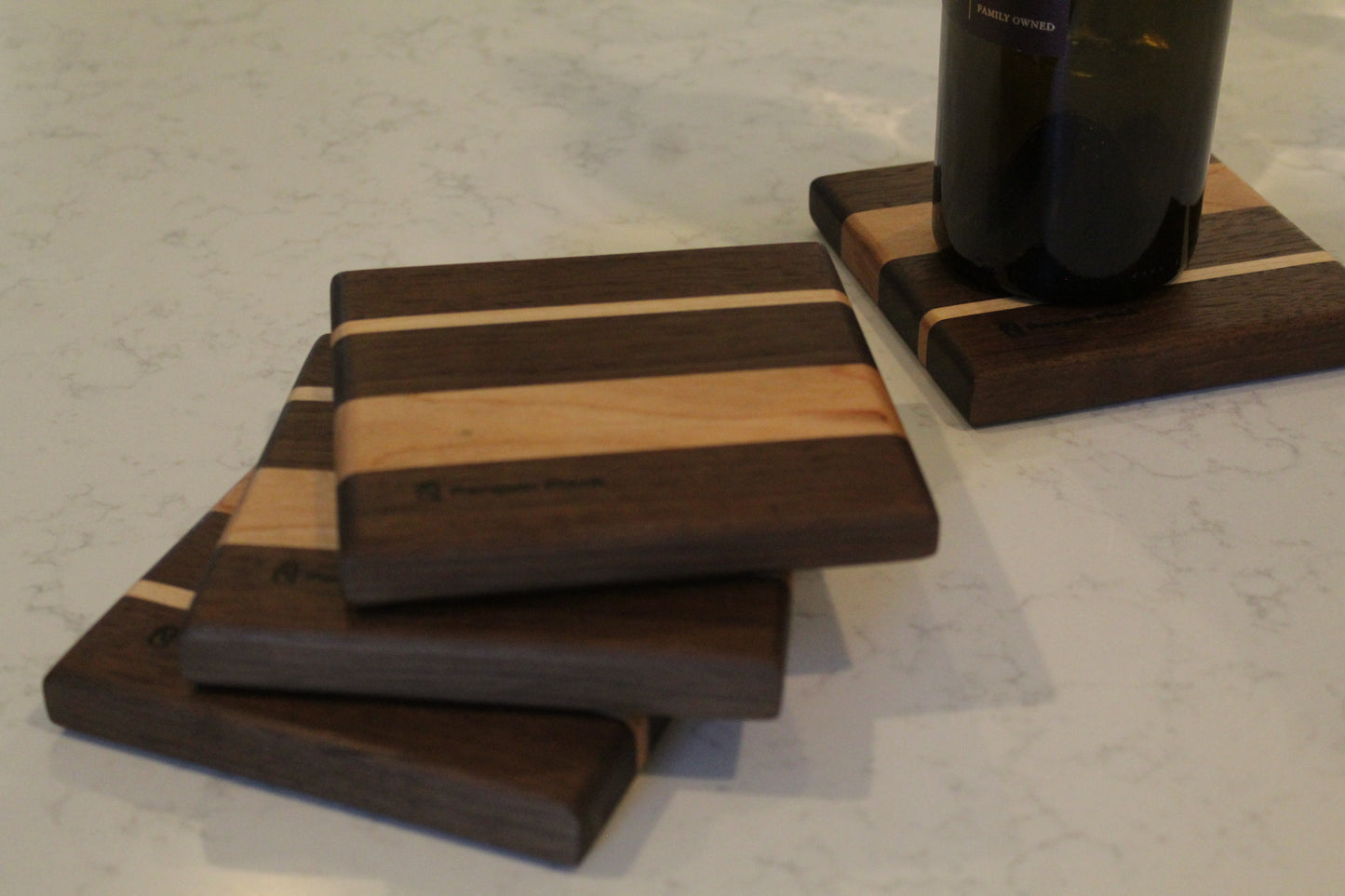 Wine bottle coaster made from walnut, cherry and maple.