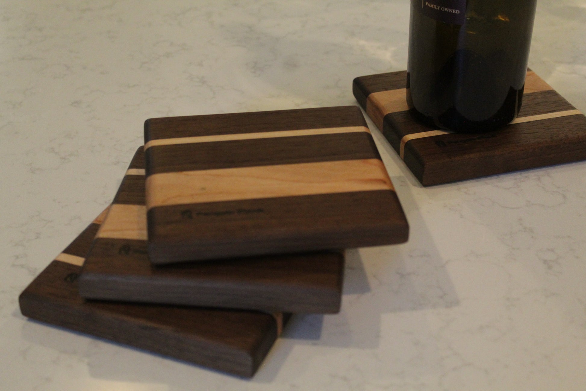 Wine bottle coaster made from walnut, cherry and maple.